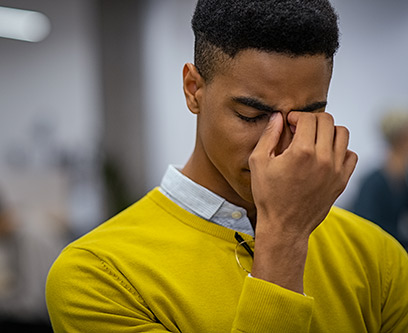 Man with his hand to his face, looking stressed out