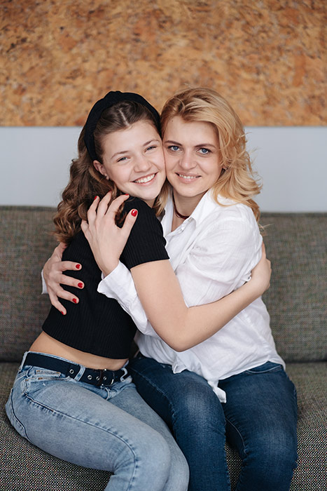 Claudia hugging her teenage daughter