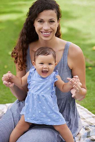 Mother and baby sitting together in a park