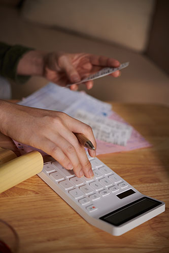 Fingers entering numbers on a calculator