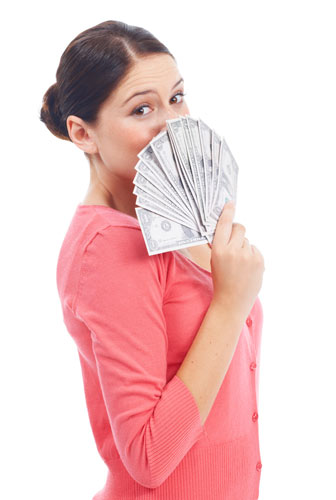 Woman holding a fan of cash up to her face, symbolizing the cash value she’s earned in her whole life insurance policy