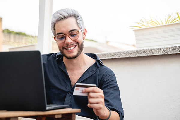 Man using a credit card to make the payment on his whole life insurance policy loan