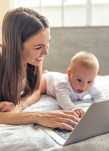 Mom using a laptop to look up ‘what is whole life insurance’