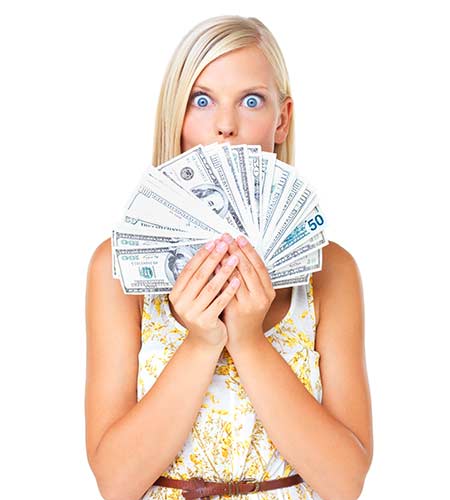 Woman holding a fan of cash from a whole life insurance withdrawal cash out
