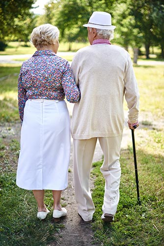 Senior couple walking in the park together