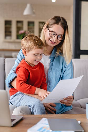 Mom and her young son looking at a life insurance loan policy statement