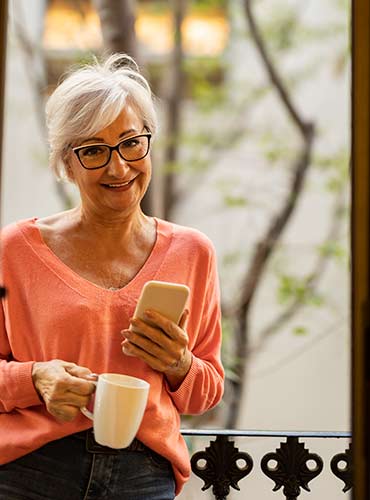 Senior woman using her smartphone to get life insurance quotes over 50