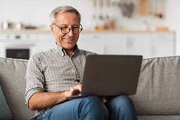 Man researching benefits of whole life insurance online
