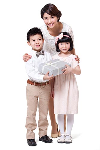 Mom and two kids holding a gift box
