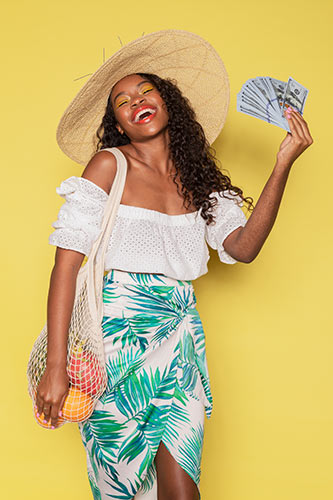 Happy woman holding out a fan of money