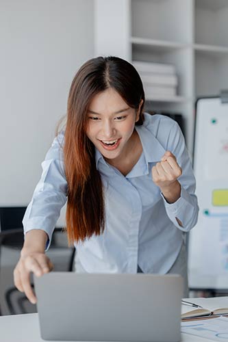 Woman checking her cash value life insurance account and smiling to see its growth over time